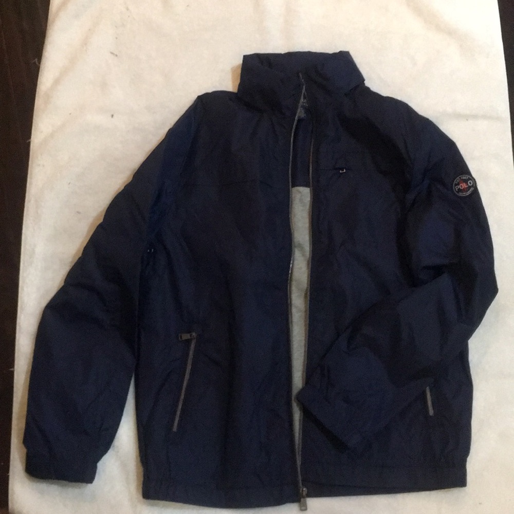 NWOT polo windbreaker. Rolls up for travel.